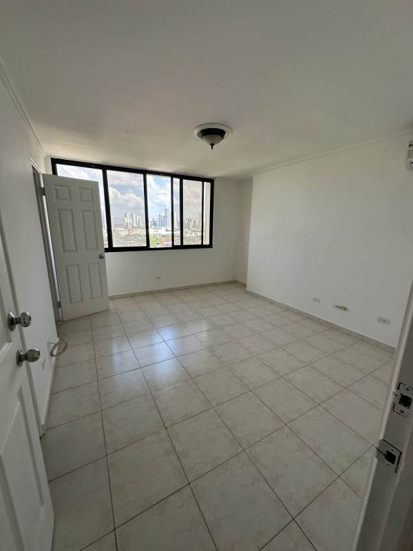 Living room with large windows and city skyline view in PH Arrecife Punta Pacífica Panama