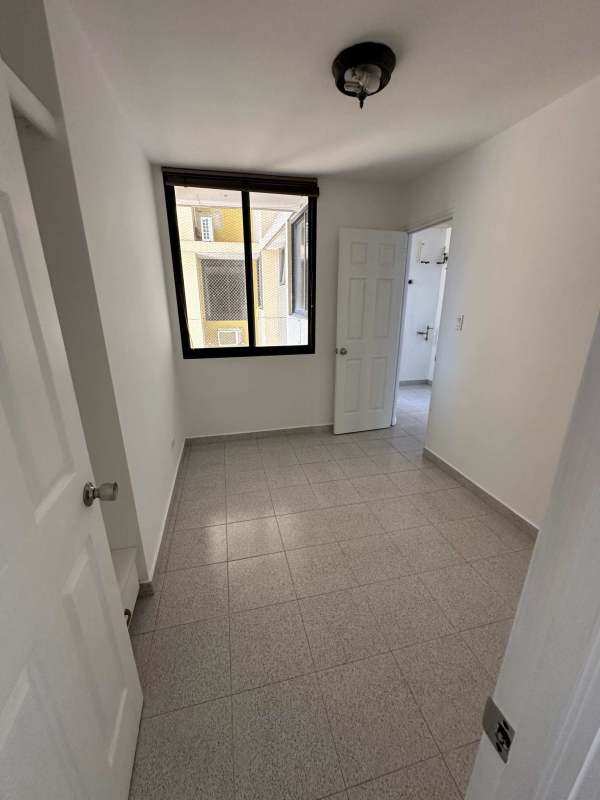 Spacious bedroom with large window and skyline views in PH Arrecife Punta Pacífica Panama