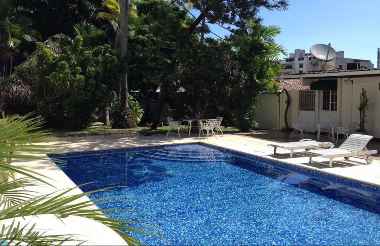 Landscaped garden with tile roof house and pool PH El Carmen Suites Panama City