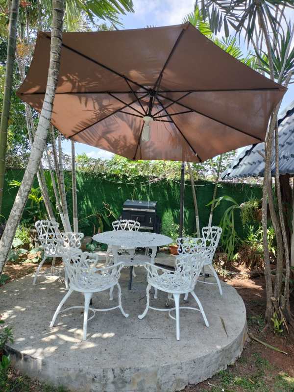 Compact kitchenette with wooden cabinets, granite counters in El Carmen Studio Panama