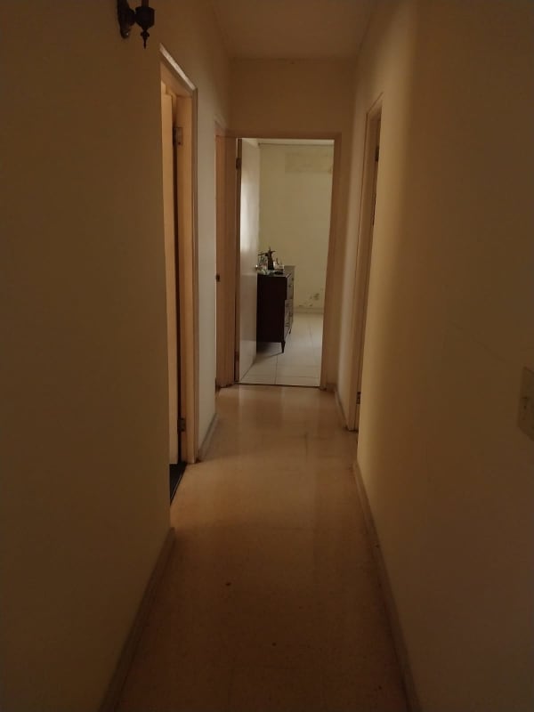 Narrow hallway leading to bedrooms beige walls in Villa de las Fuentes Panama