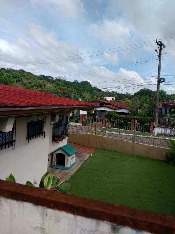 Backyard with covered terrace garden and dog house in Villa de las Fuentes Panama