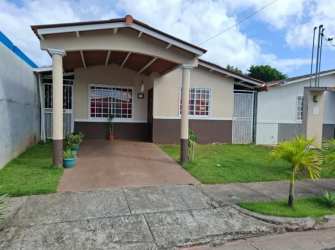 Bright dining area with front door, window curtains, and breakfast bar in house for sale Vacamonte Panama