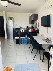 Kitchen and dining space with appliances and ceiling fan in Playa Corona beachfront Panama