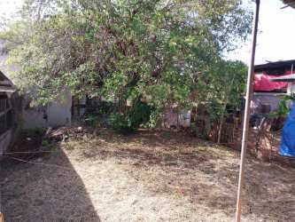 Driveway entry with metal gate in affordable house for sale Chitré Panama