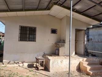Exterior with metal roof, barred windows, and outdoor sink house for sale Chitré Panama
