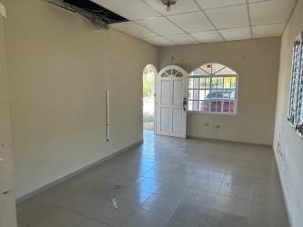 Bright living area with tiled floors and arched window in house for sale Chitré Panama