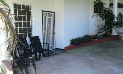 Covered patio entrance metal door seating area garden duplex rental Chitré Panama