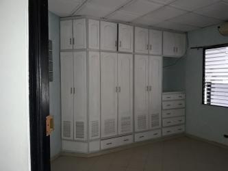 Bedroom with built-in wardrobe AC louvered window in duplex rental Chitré Panama