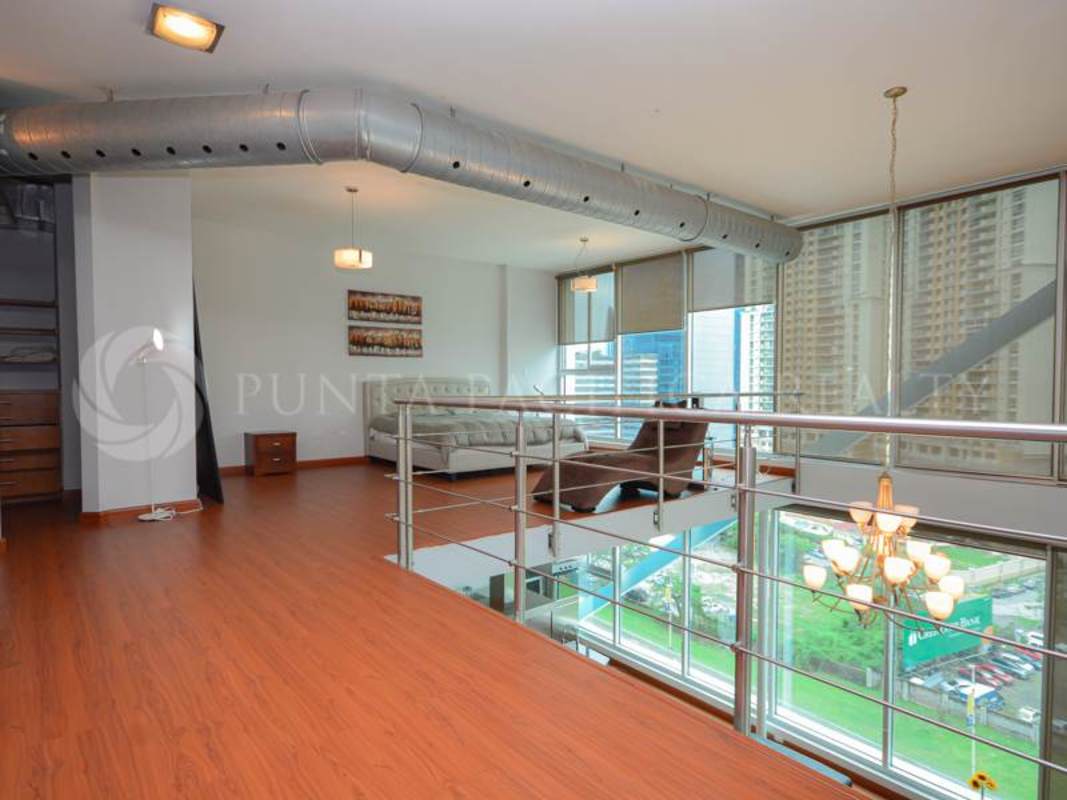 Contemporary master bedroom with floor-to-ceiling window ocean skyline views in Loft 4-41 Panama City