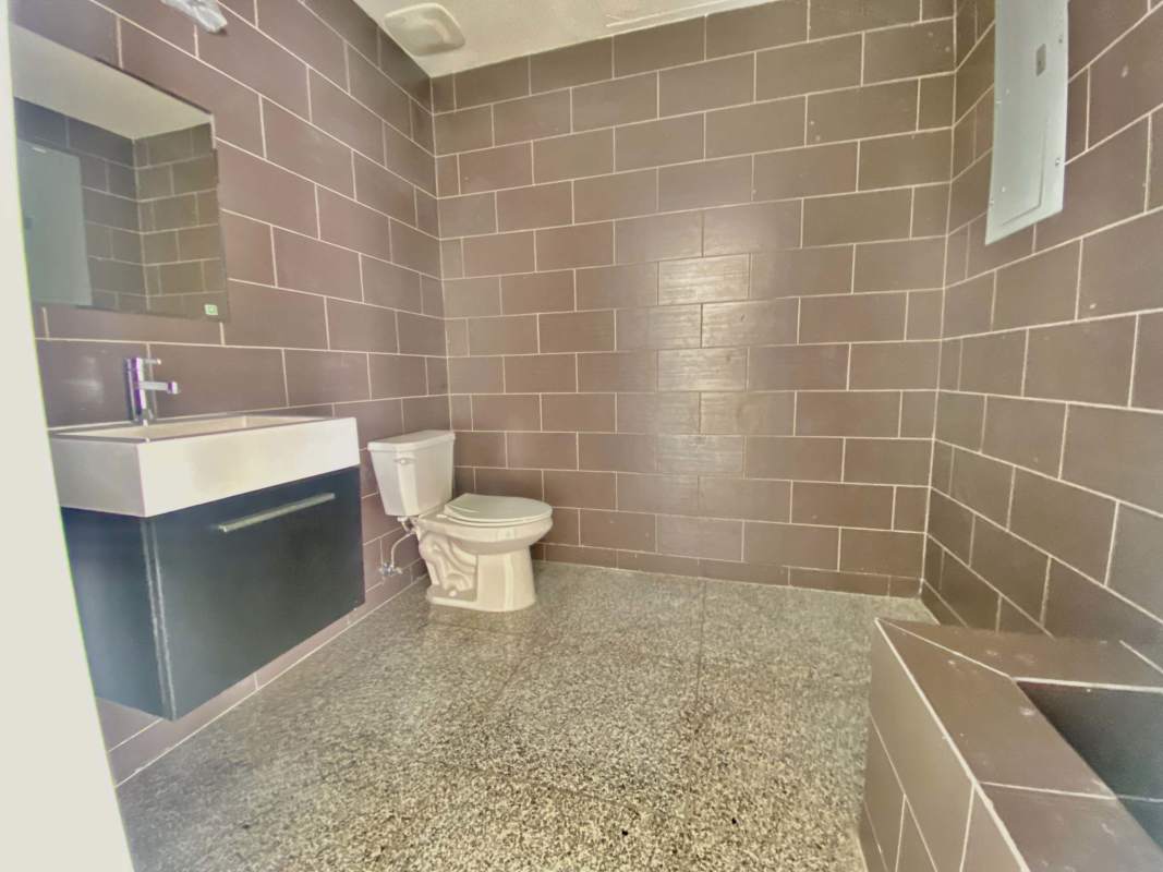 Private in-unit bathroom with ceramic tile fixtures office rental Costa del Este Panama