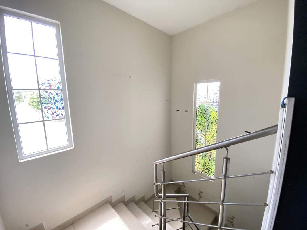 Kitchen equipped with granite counters and wood cabinets in Reserva de Versalles Costa Sur Panama
