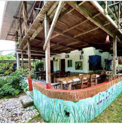 Colorful facade and wooden balcony of Caribbean eco-hostel property