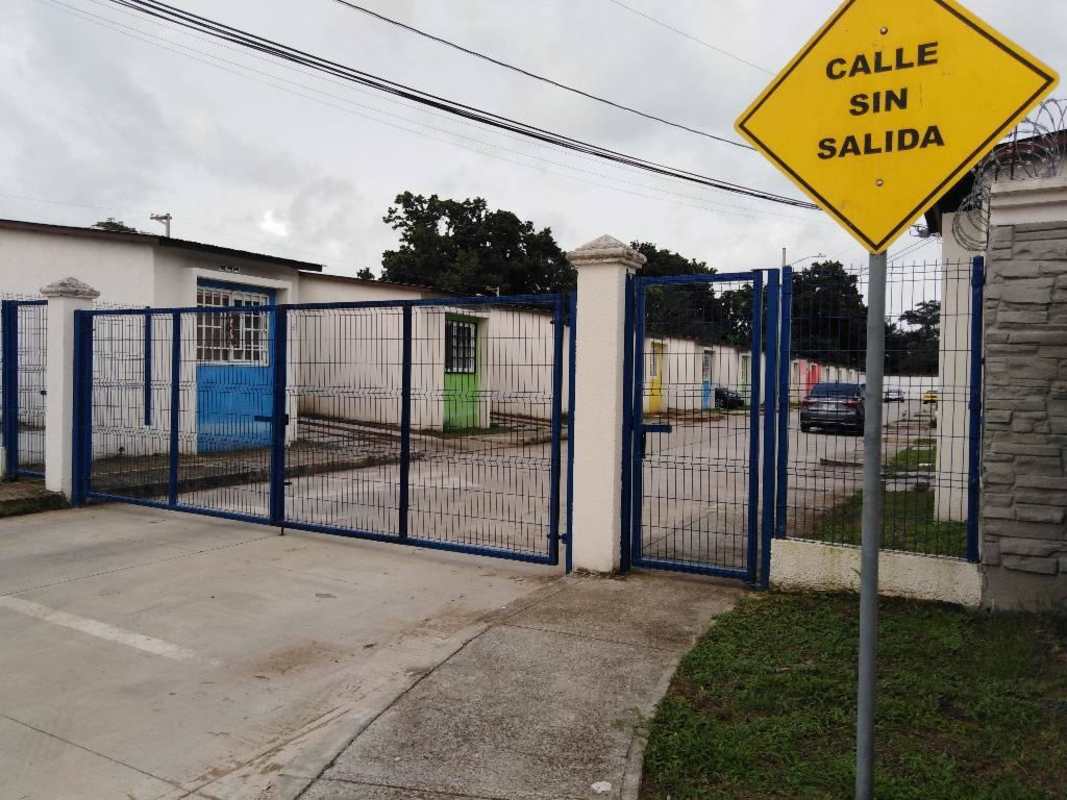 Gated community entrance with security fence and signage in Pacora Panama