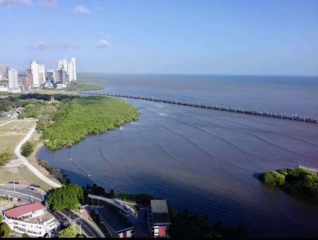 Spacious kitchen with granite countertops, wood cabinets and stainless appliances in Panama condo