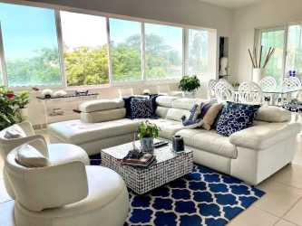 Contemporary open plan living area with coastal decor Punta Barco Village