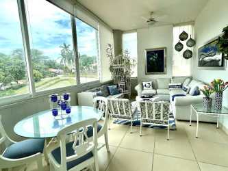 Open living room with large windows and garden views in Punta Barco Village Panama