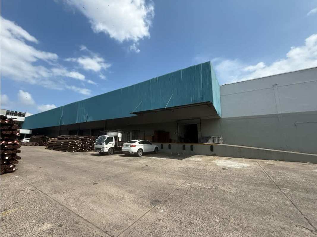 Exterior view of large warehouse with loading docks and truck parking Panama