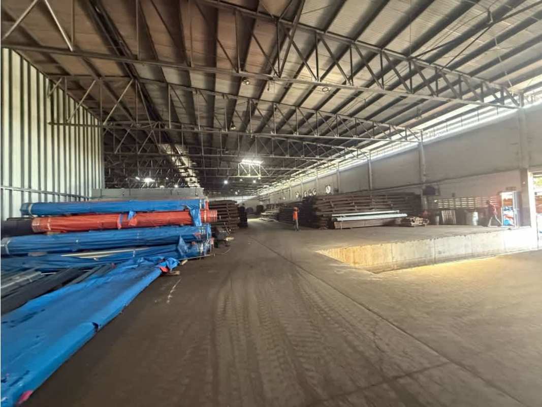 Wide open industrial warehouse interior with stacked goods Panama City