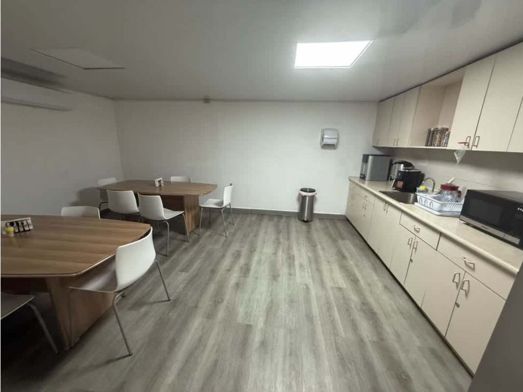 Modern conference room with large table, window blinds, TV in warehouse office Panama