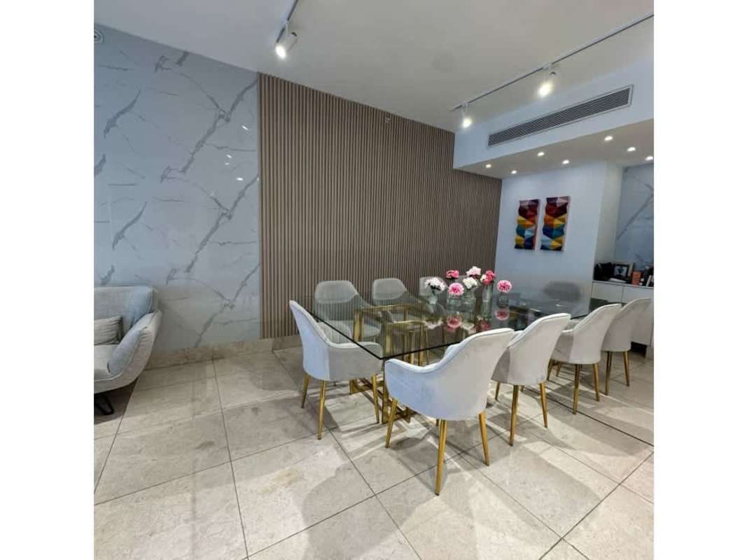 Bright living dining area with balcony overlooking city skyline at PH Deluxe Residence Panama City