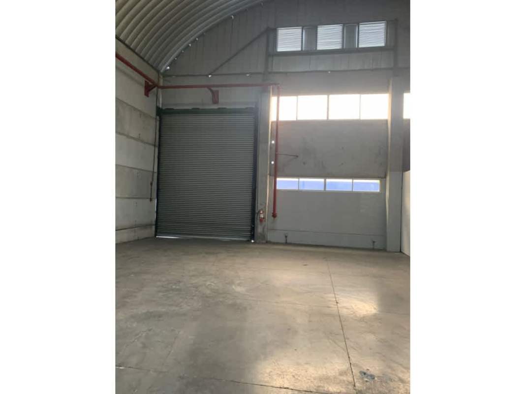 Empty industrial warehouse with high metal roof concrete floor large open space in Panama City