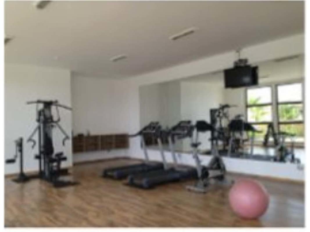 Luxury living room with chandelier, large glass doors, neutral tones in Sunset Coast Costa Sur Panama City