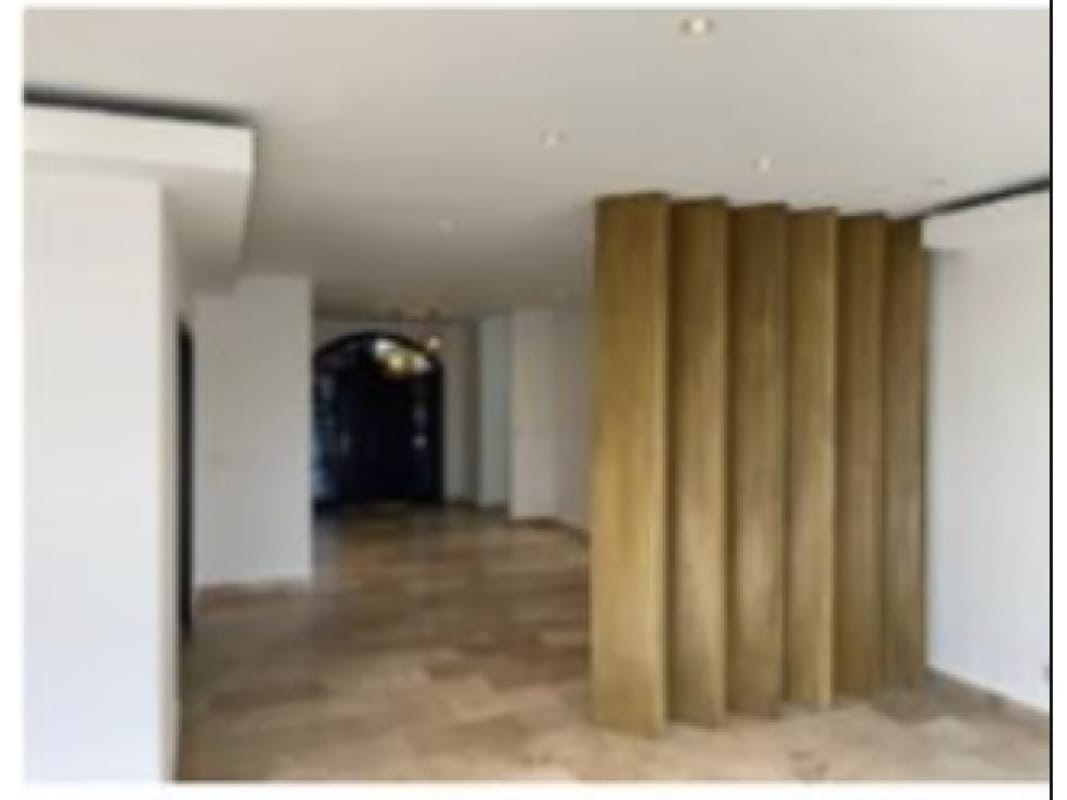 Modern hallway with white walls, marble flooring, wood divider at Sunset Coast Costa Sur Panama