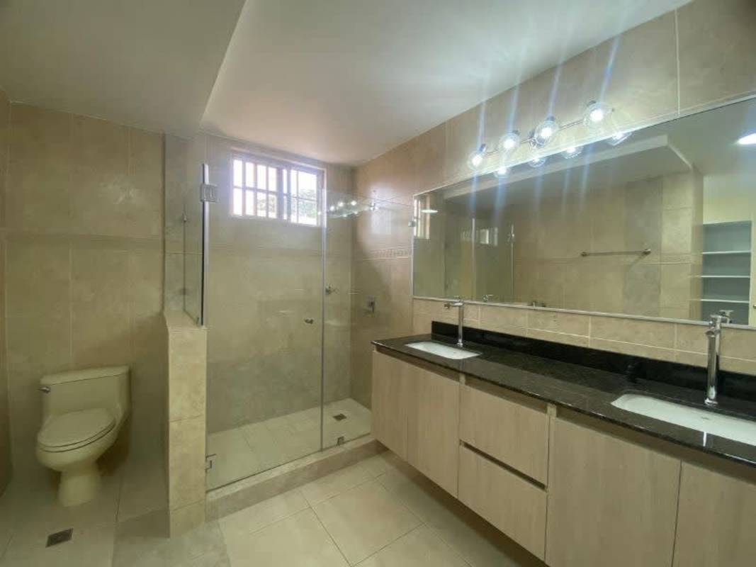 Living room with large windows, tiled flooring, and AC in renovated house Albrook Gardens Clayton Panama