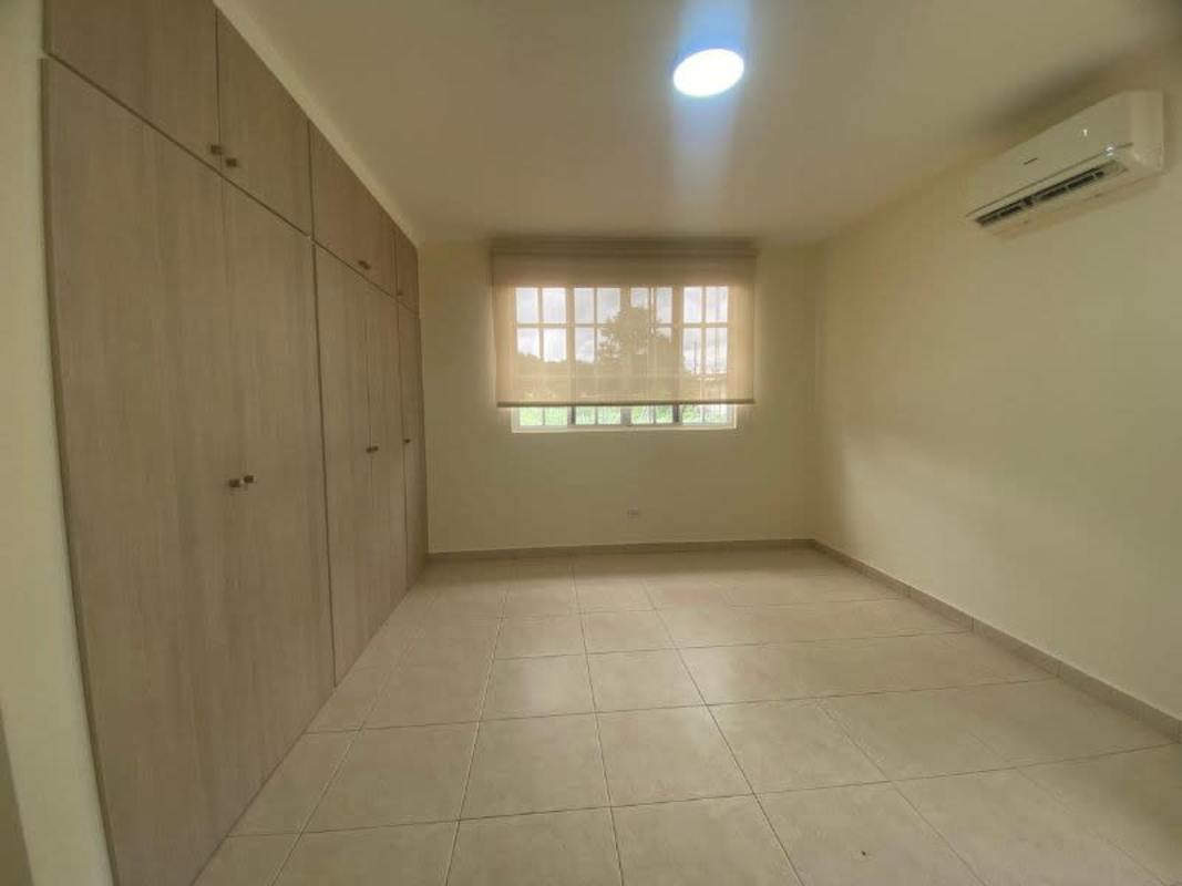 Spacious backyard with lawn and covered terrace in Albrook Gardens home Clayton Panama