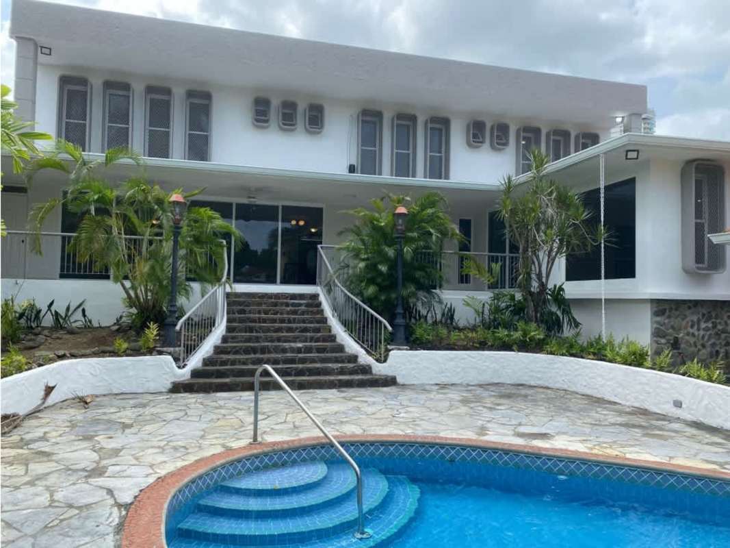 Private outdoor swimming pool and jacuzzi surrounded by garden in luxury residence Panama