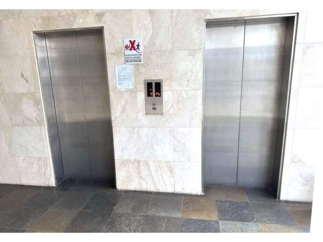 Multi-story modern building with glass windows and commercial facade Plaza Morica Panama City