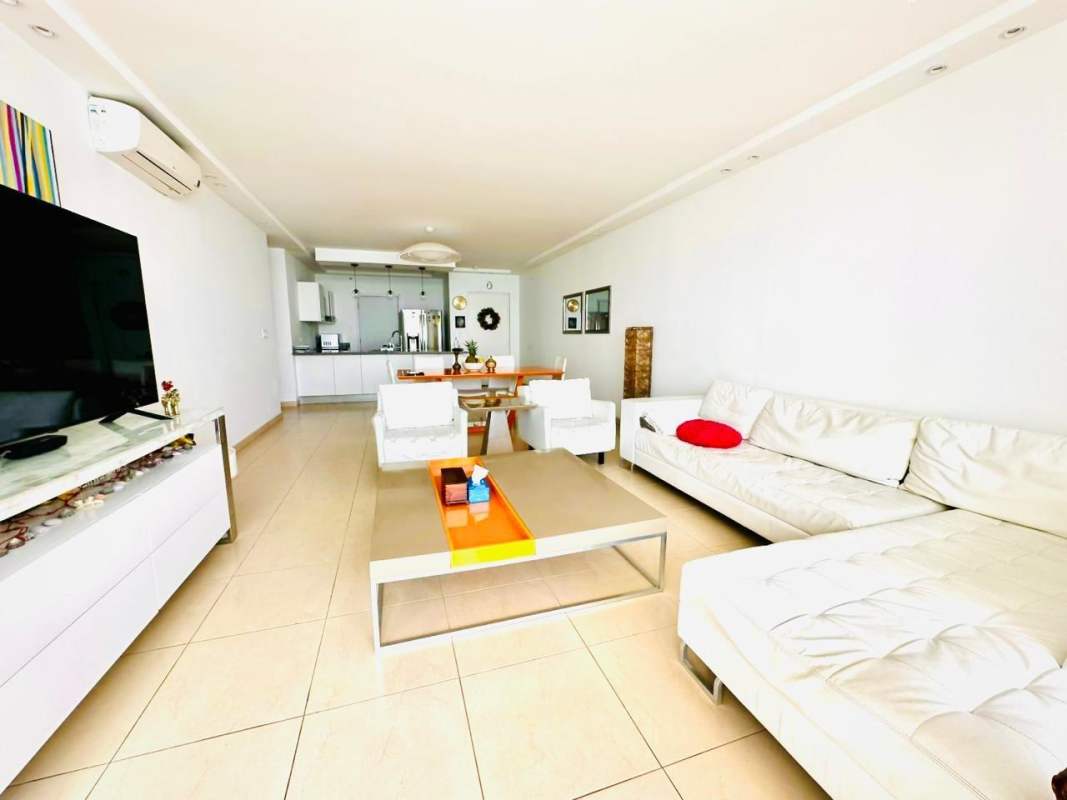 Bright modern open-plan living room with sectional sofa and flat-screen TV PH BICSA Panama City