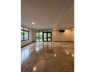 Large living room with marble flooring, windows, open plan PH Nativa Panama Pacifico