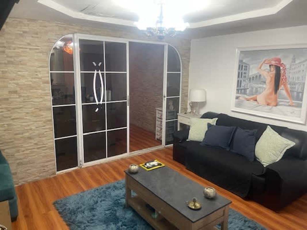 Bedroom wood floor upholstered headboard closet window Altos de la Calzada Panama house