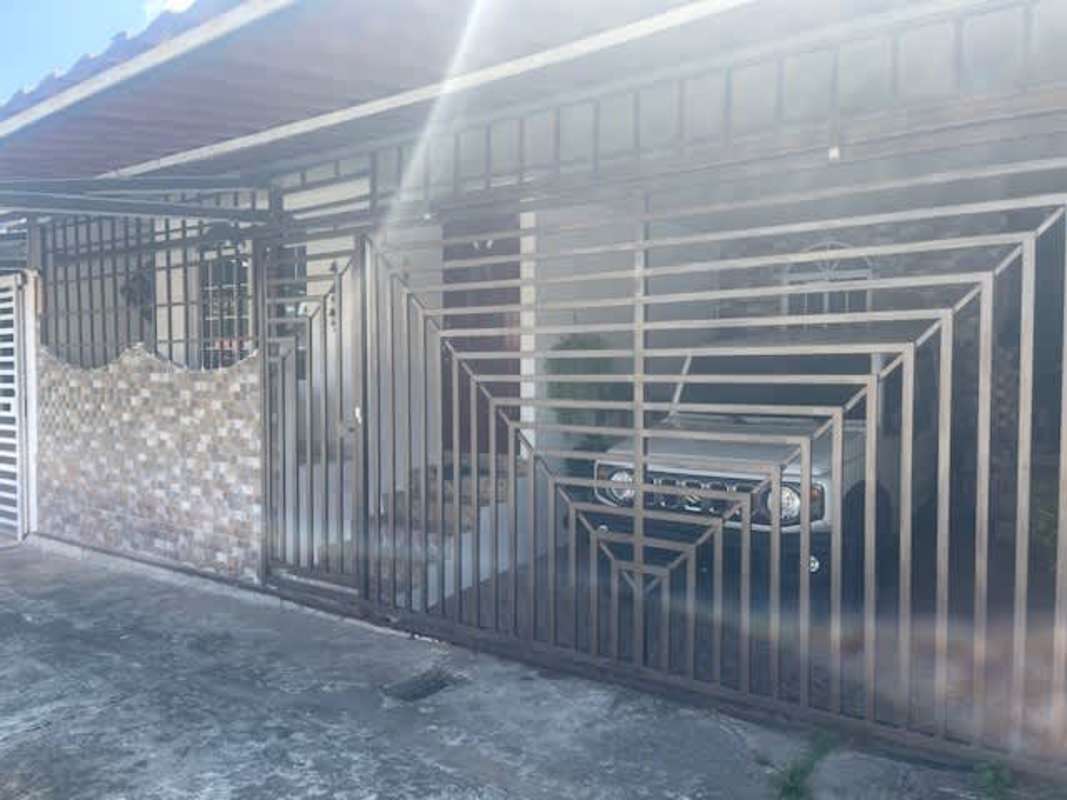 Functional kitchen with white cabinets pass-through counter Altos de la Calzada Panama