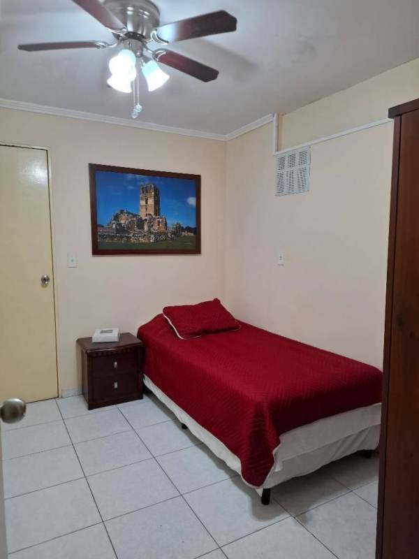 Kitchen with dark wood cabinets, granite counters, refrigerator, ceiling fan in PH Vista Hermosa El Cangrejo Panama