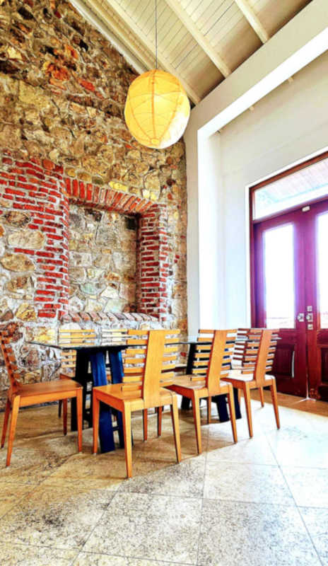 Balcony with Mediterranean tiles offering ocean and historic Casco views in Panama City penthouse.