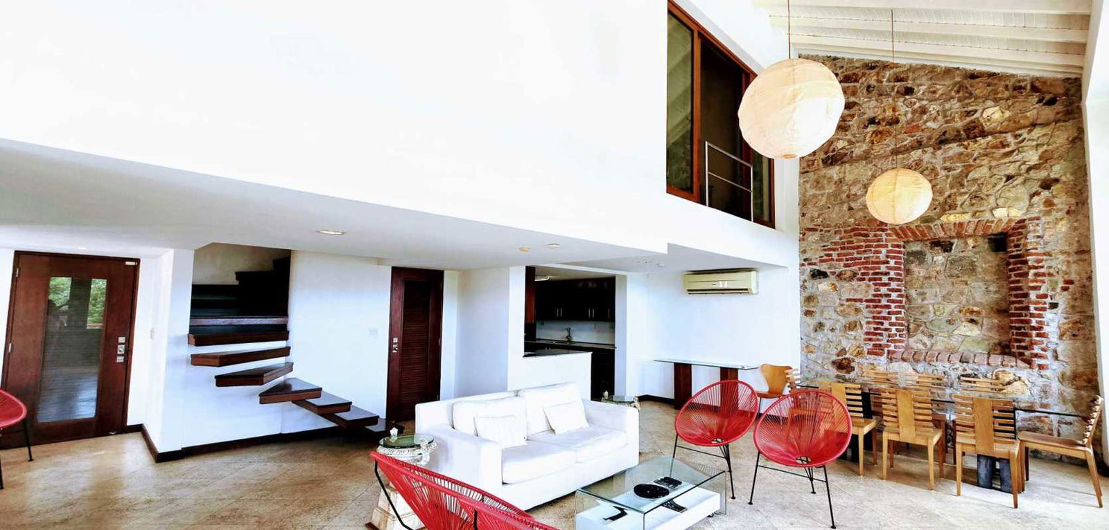 Spacious bright living room with balcony access in restored colonial penthouse Casco Viejo.