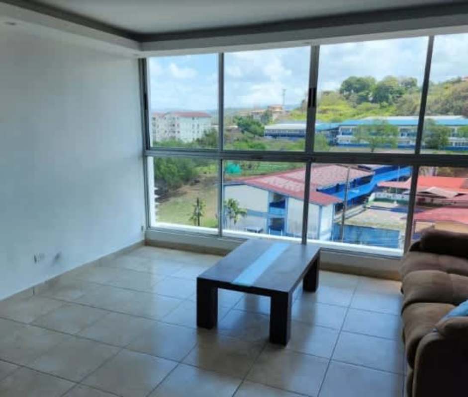 Bright living room with large floor-to-ceiling windows urban view PH Torres del Crisol in Panama City
