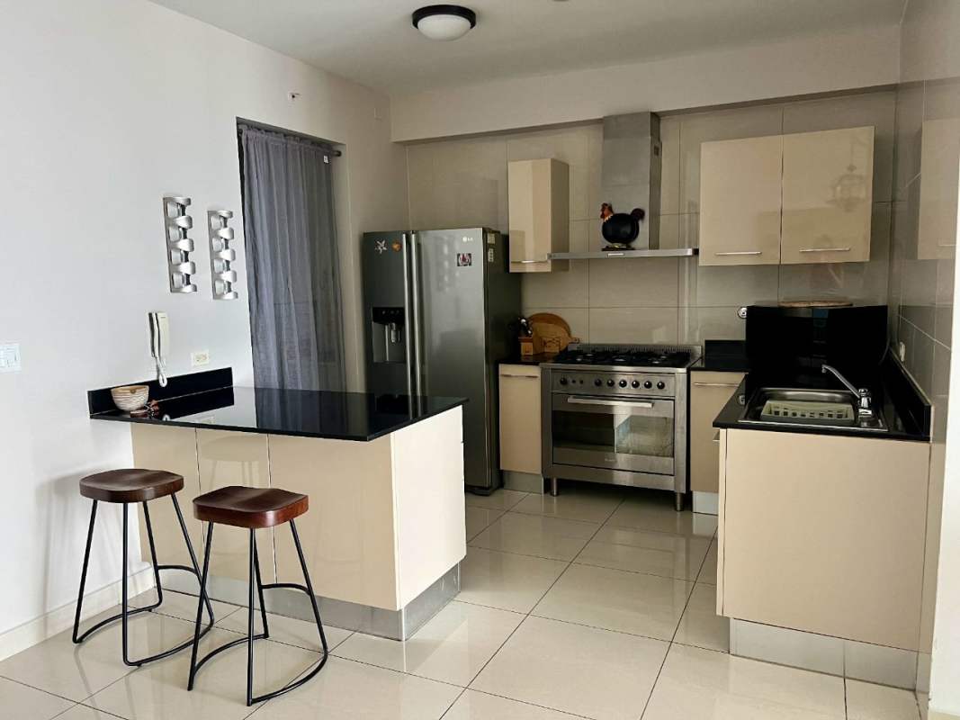 Open kitchen with granite countertops, appliances inside PH Allure Avenida Balboa Panama