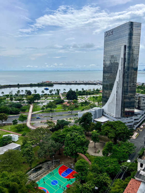 Furnished bedroom with large window, ocean and skyline view in PH Allure Panama City