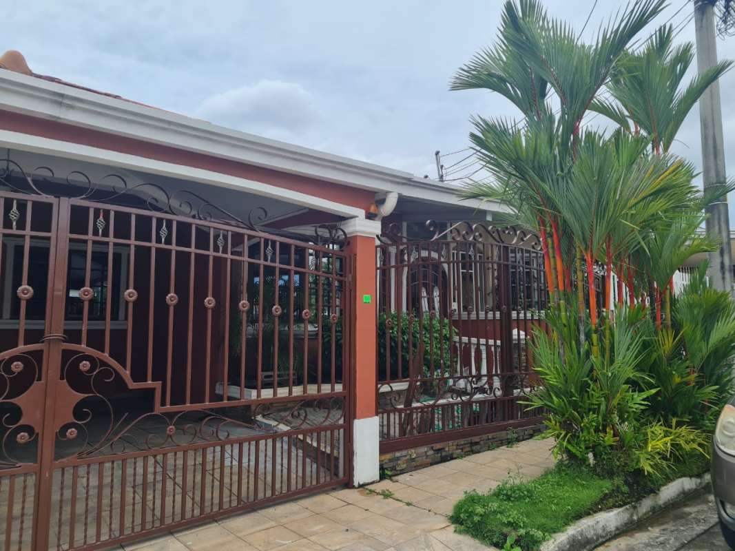 Mediterranean-style gated entrance with lush tropical garden Praderas de San Antonio Panama