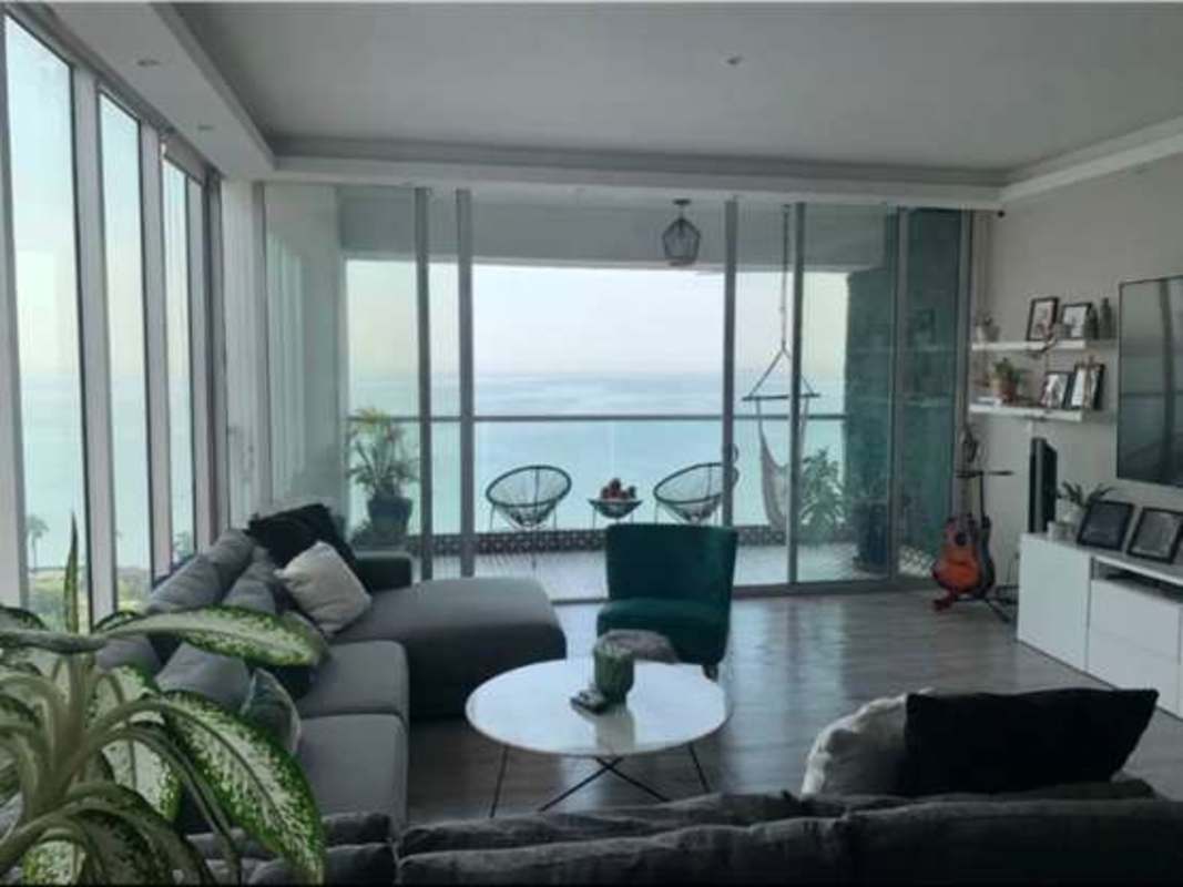Contemporary living room with oceanfront balcony, floor-to-ceiling windows PH Rivage Tower Panama City