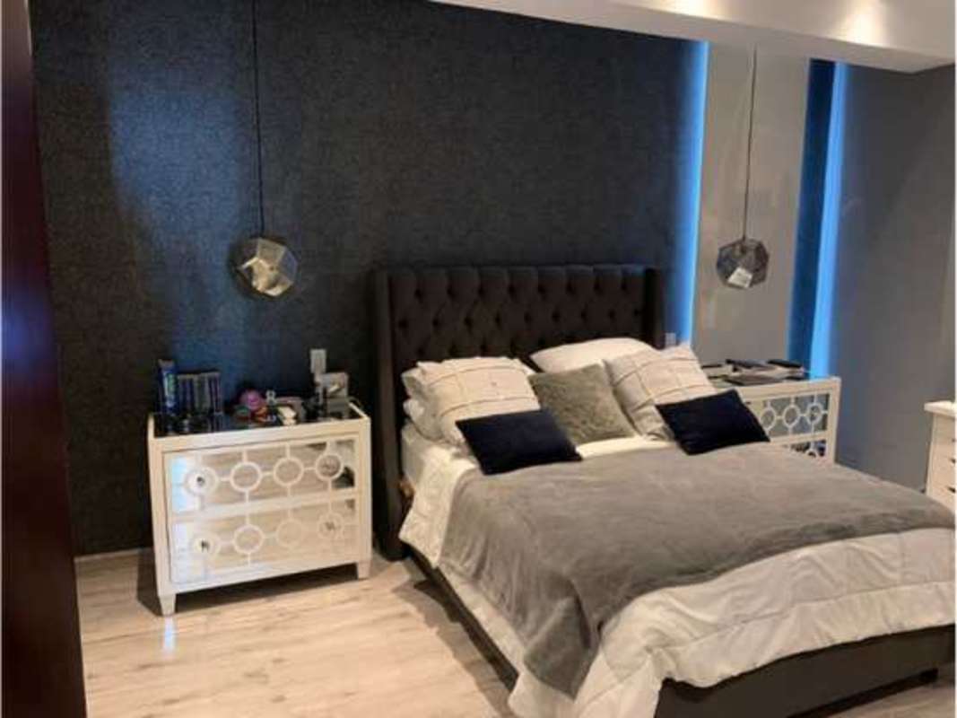 Master bedroom with large windows and ocean views at PH Rivage Tower Avenida Balboa Panama