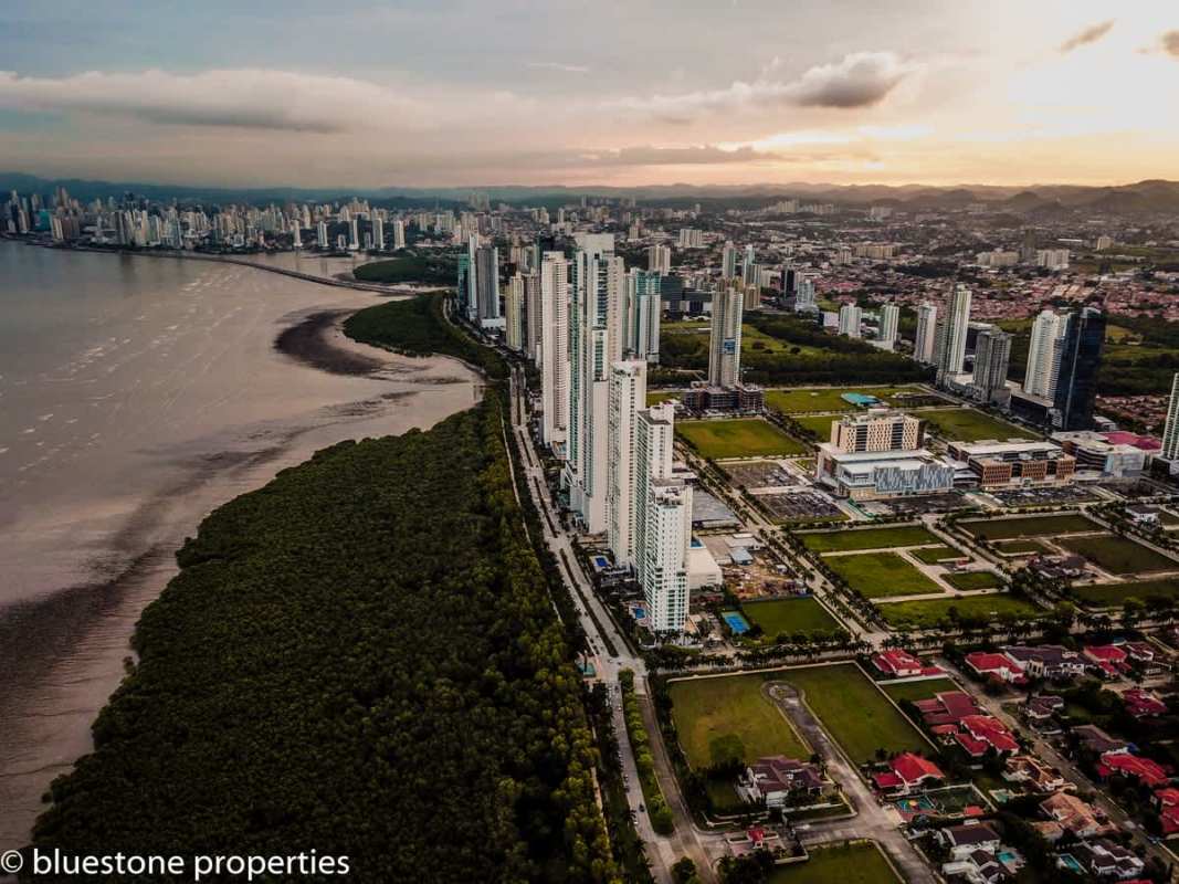 Family entertainment room with custom wood cabinetry, marble floors, flat screen TV Costa del Este luxury home