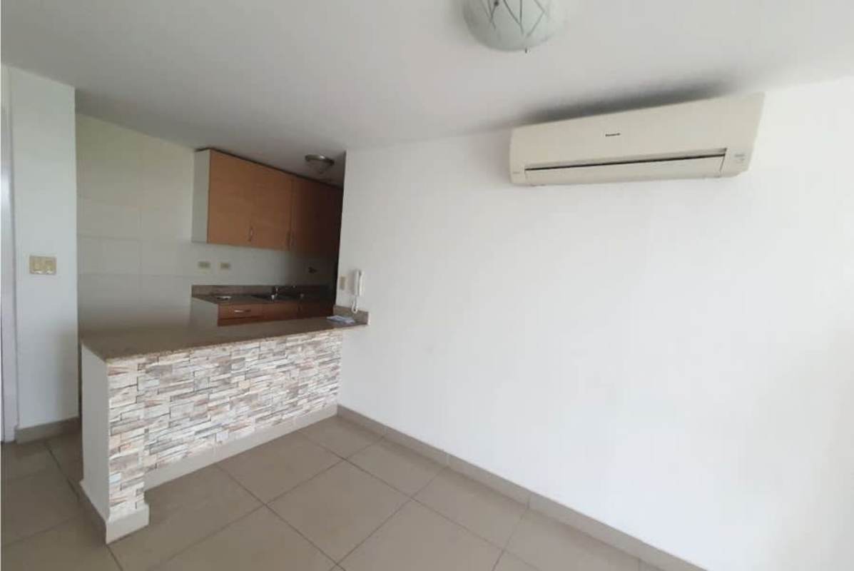 Compact modern kitchen with granite countertops, cabinets, and window PH 4 Islas Panama