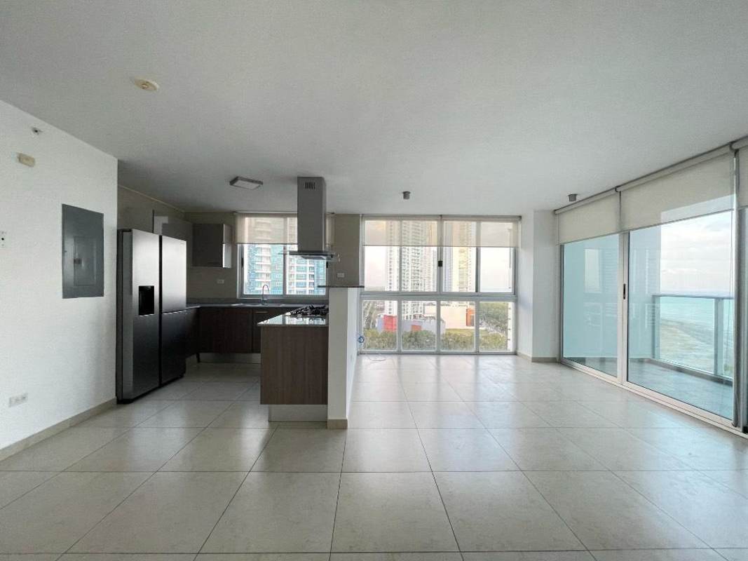 Stylish open-plan kitchen with granite counters and stainless appliances overlooking city skyline in Costa del Este Panama