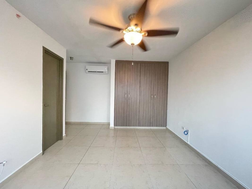 Bedroom space with built-in closet, split AC, and ocean city views in PH Lumiere Costa del Este Panama