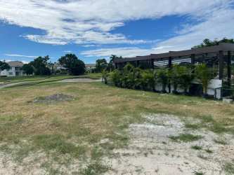 Manicured fairways, palm trees and clubhouse at Bijao Beach Resort Panama